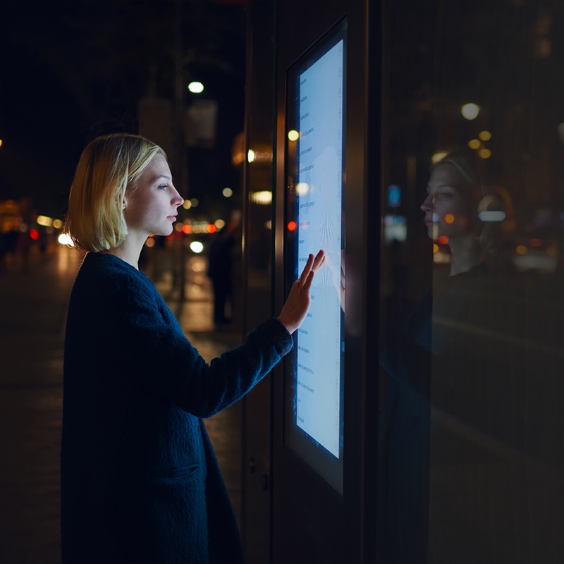 A woman using IOT based retail software on street